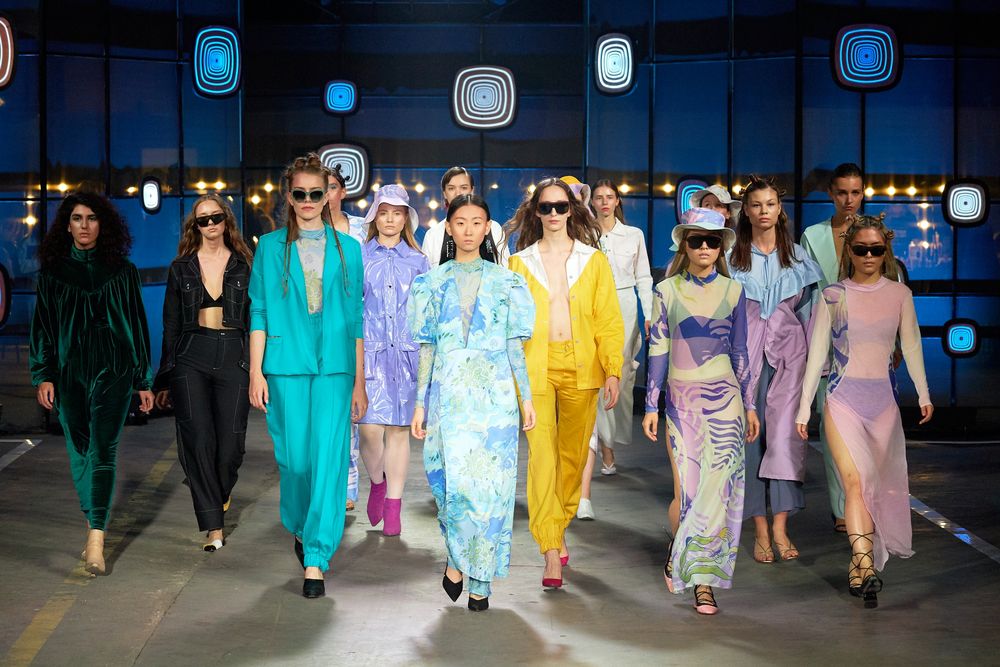 Models walking a brightly lit fashion runway
